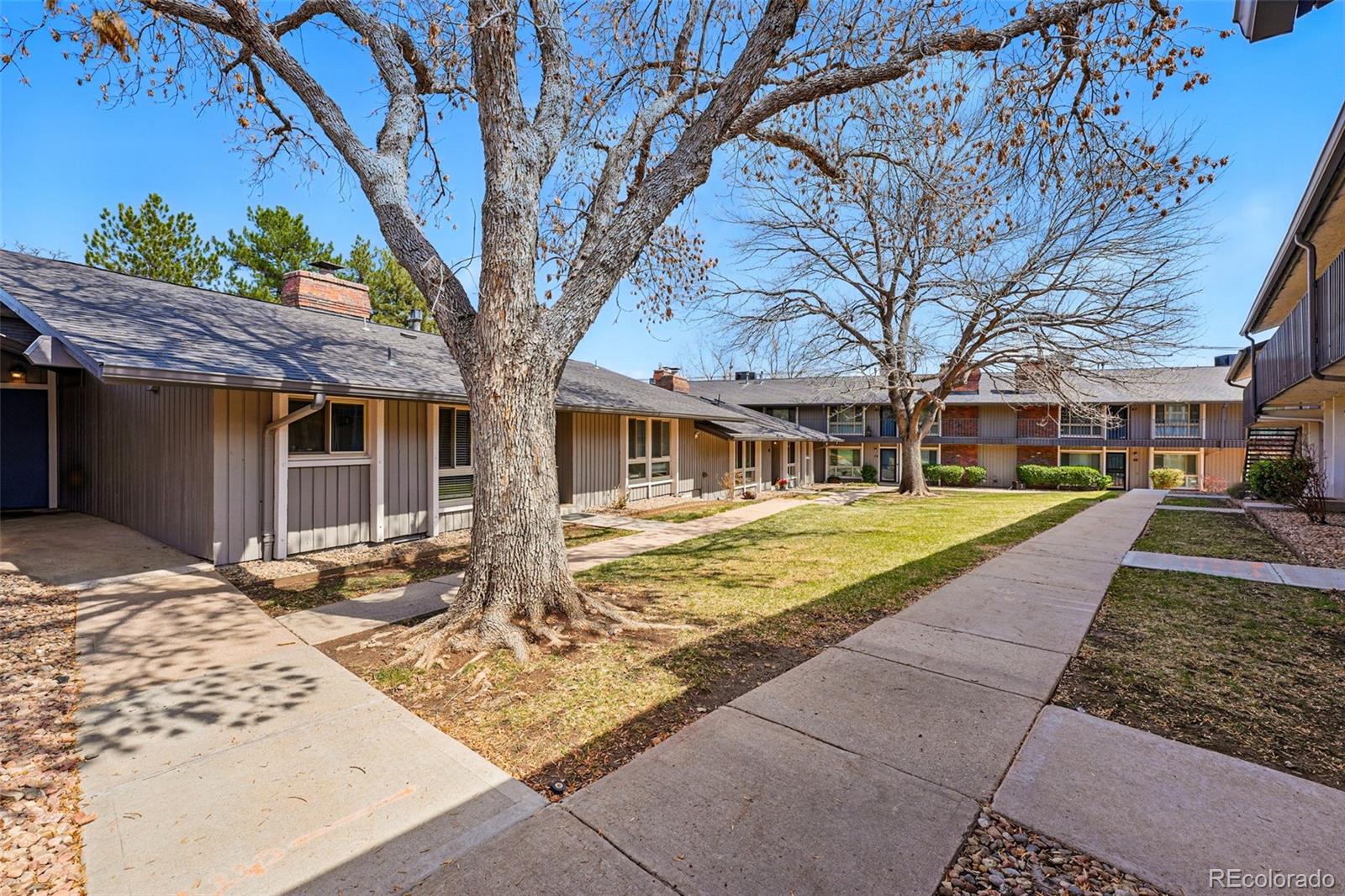 6495 East Happy Canyon Road, Unit 62 Denver, CO 80237 - Photo 23 of 23 a front view of a house with a yard