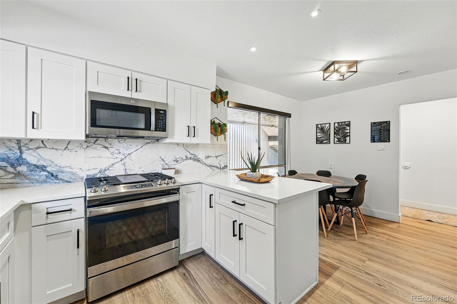 6495 East Happy Canyon Road, Unit 62 Denver, CO 80237 - Photo 3 of 23 a kitchen with a stove and a microwave
