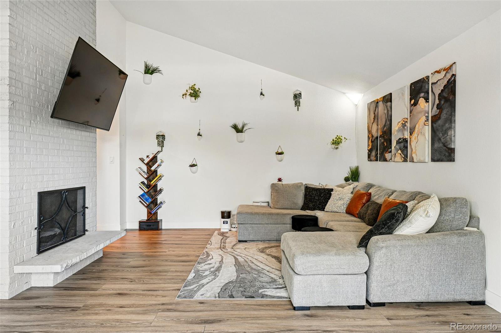 6495 East Happy Canyon Road, Unit 62 Denver, CO 80237 - Photo 7 of 23 a living room with furniture and a fireplace