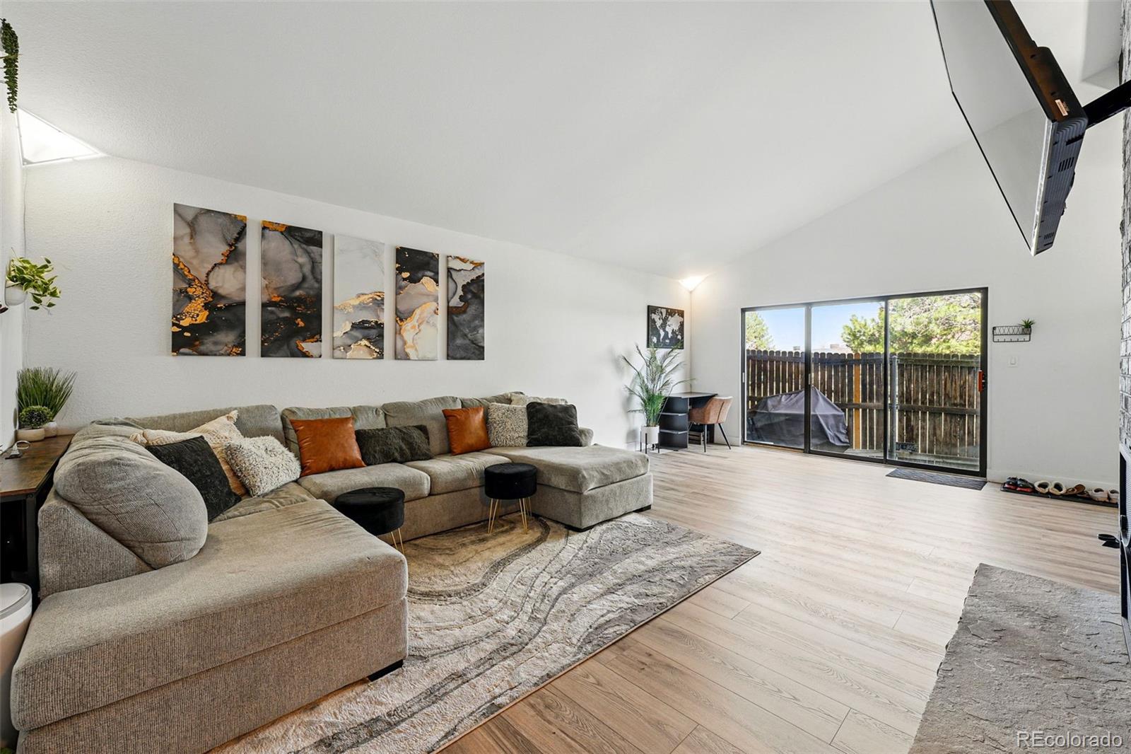 6495 East Happy Canyon Road, Unit 62 Denver, CO 80237 - Photo 8 of 23 a living room with furniture large window and glass door