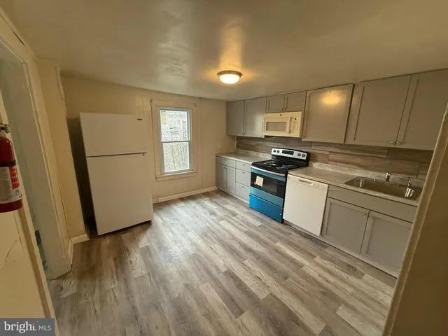 a view of a kitchen from the hallway