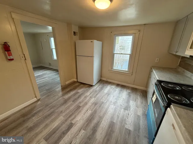a view of a livingroom with wooden floor and window
