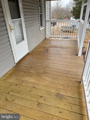 a kitchen with a sink a stove top oven and wooden floor