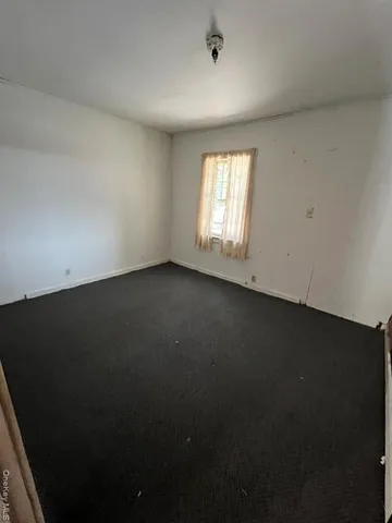 a room with a sink and a bed