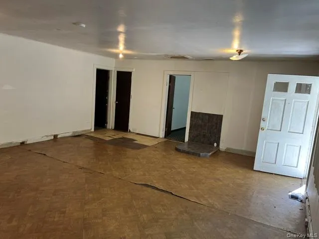 a view of a room with wooden floor