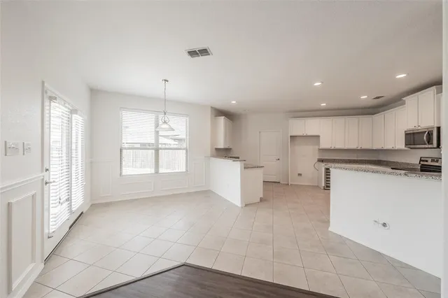a kitchen with stainless steel appliances a refrigerator sink and cabinets
