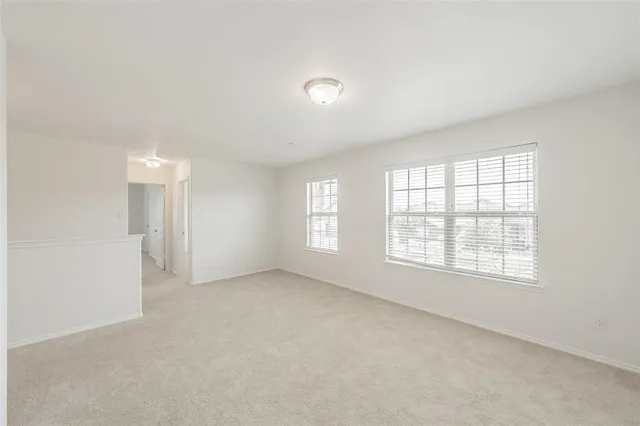 an empty room with a empty space and windows