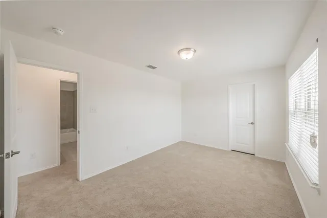 an empty room with windows and closet