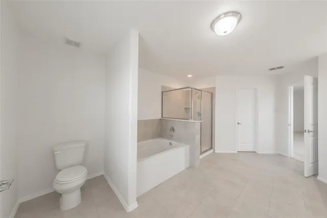 a bathroom with a toilet a sink and bathtub