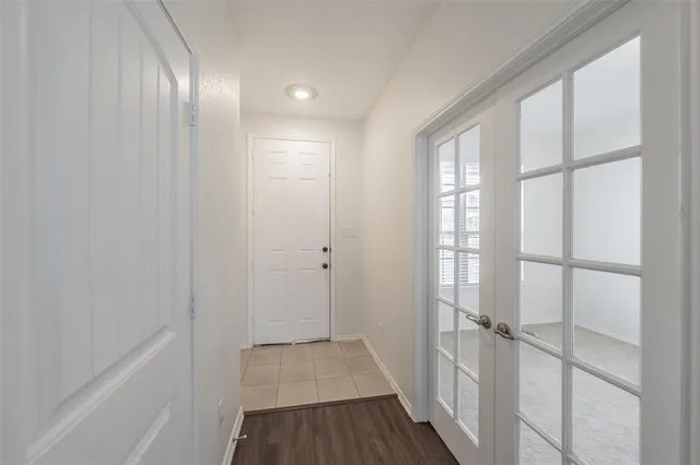 a view of a room with wooden floor and windows
