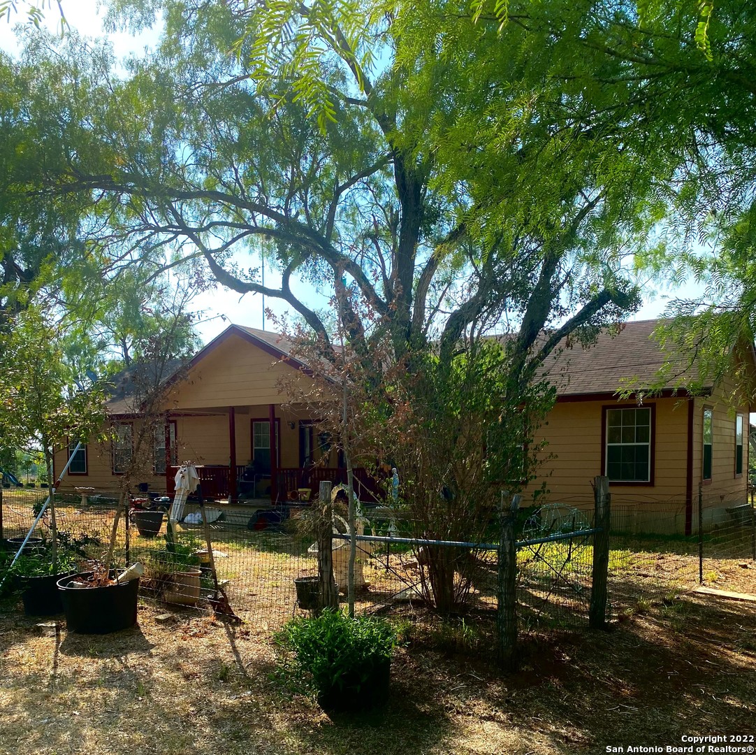 13220 Highway 1604 Loop San Antonio, TX 78263 - Photo 31 of 49 a front view of a house with garden