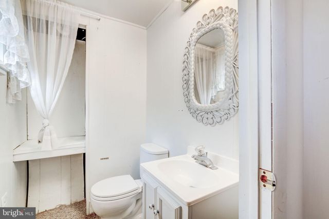 a bathroom with a sink mirror and toilet