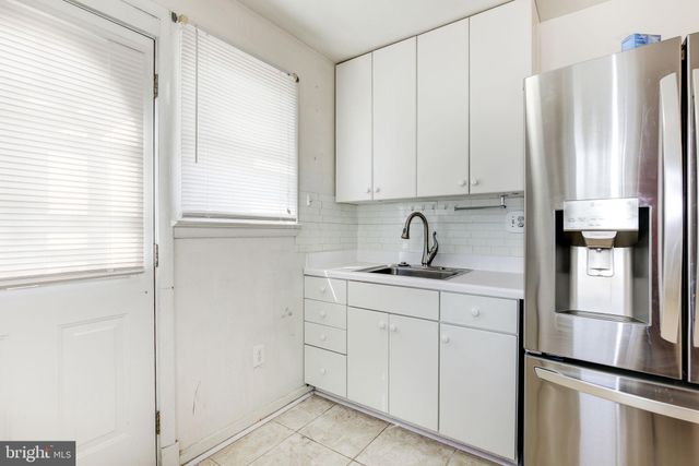 a kitchen with appliances cabinets and a sink