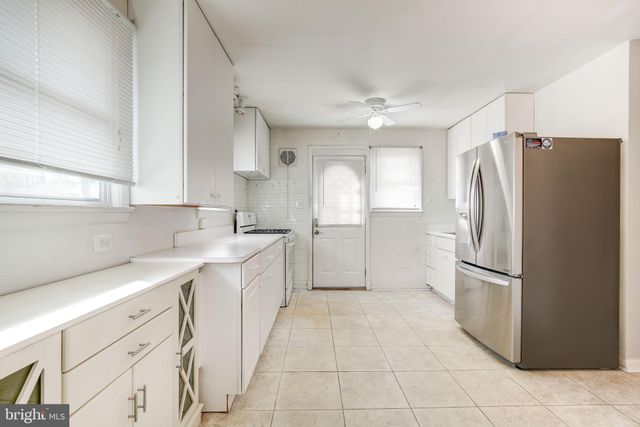 a kitchen with a refrigerator sink and cabinets