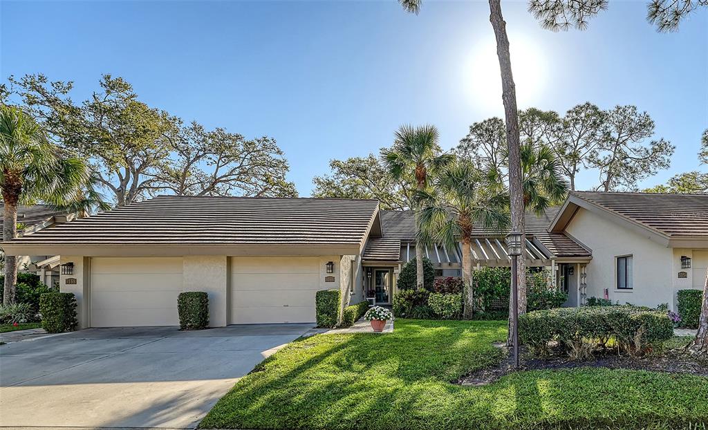 3156 Sandleheath, Unit 75 Sarasota, FL 34235 - Photo 1 of 1 a front view of a house with garden