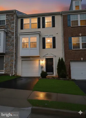 a front view of a house with garage and yard