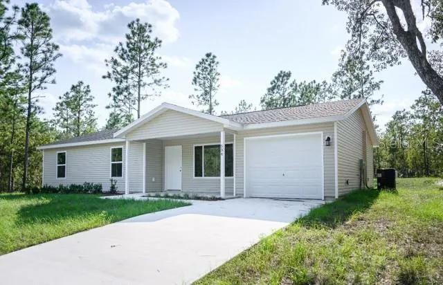 a front view of house with yard and trees