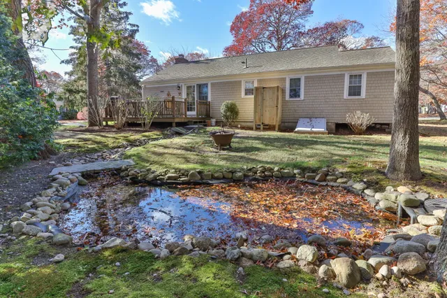 a view of a house with backyard and sitting area