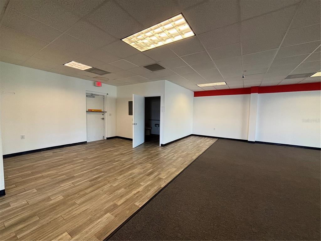 2672 Tamiami Trail, Unit 6B 7B Port Charlotte, FL 33952 - Photo 16 of 36 an empty room with wooden floor and windows