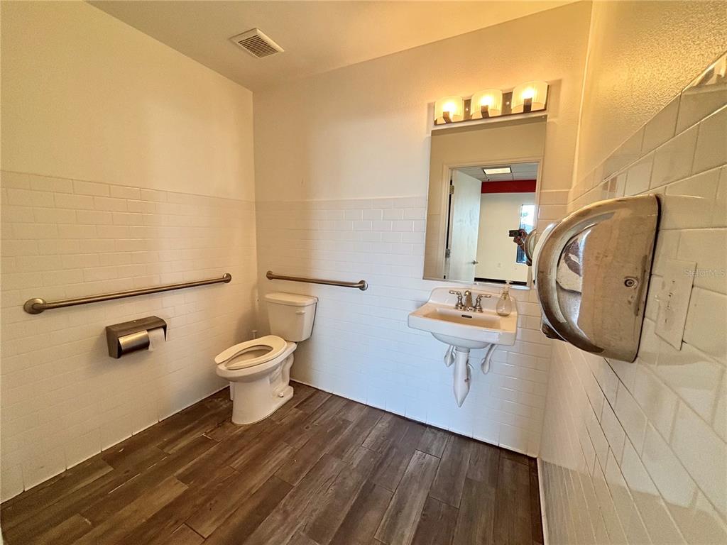2672 Tamiami Trail, Unit 6B 7B Port Charlotte, FL 33952 - Photo 20 of 36 a bathroom with a toilet sink and mirror