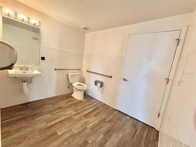 a bathroom with a toilet a sink and shower