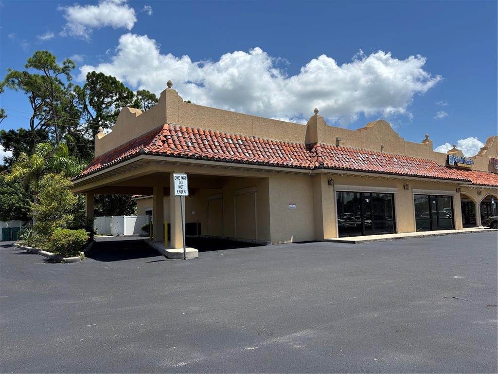 2672 Tamiami Trail, Unit 6B 7B Port Charlotte, FL 33952 - Photo 26 of 36 a front view of a house with a garden