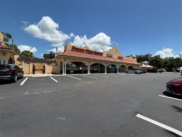 a front view of a building with parking