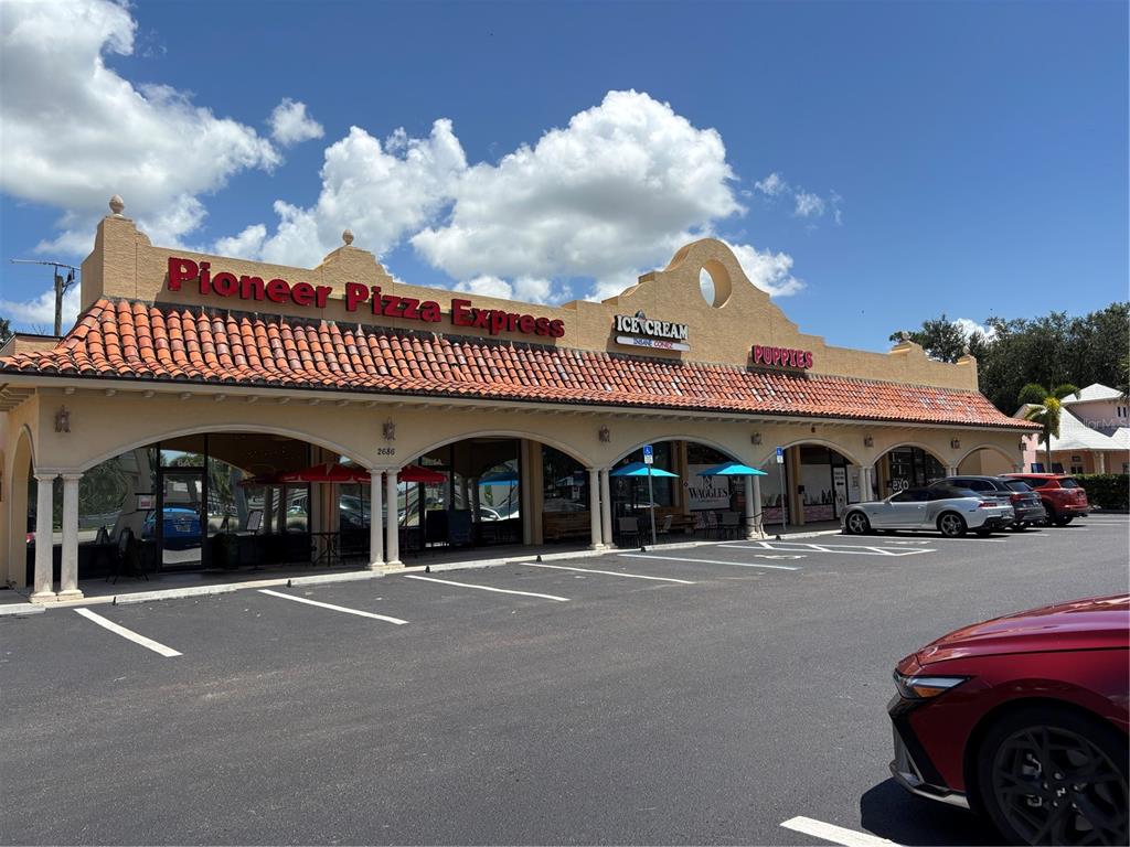 2672 Tamiami Trail, Unit 6B 7B Port Charlotte, FL 33952 - Photo 32 of 36 a front view of a building with parking