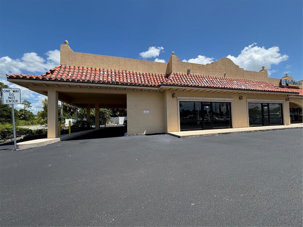 2672 Tamiami Trail, Unit 6B 7B Port Charlotte, FL 33952 - Photo 7 of 36 a view of a room with a large window and chandelier