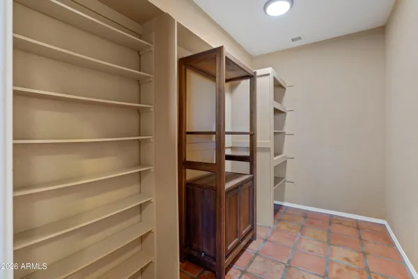 a bathroom with a toilet sink vanity and mirror