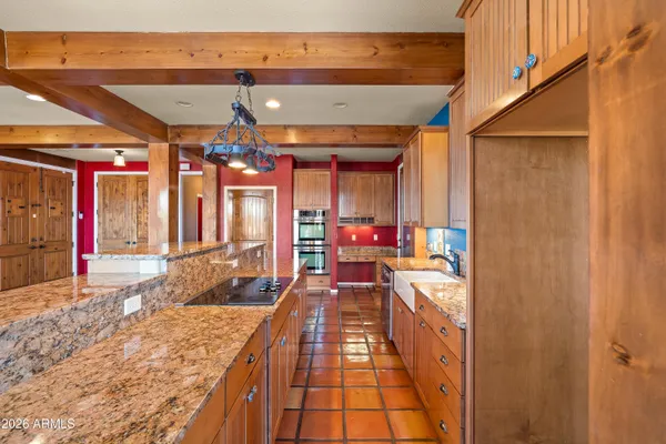 a spacious bathroom with a granite countertop sink and a large mirror