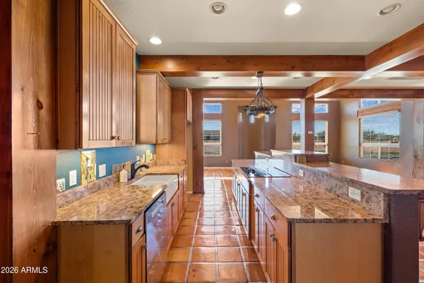a room with a granite countertop sink and cabinets
