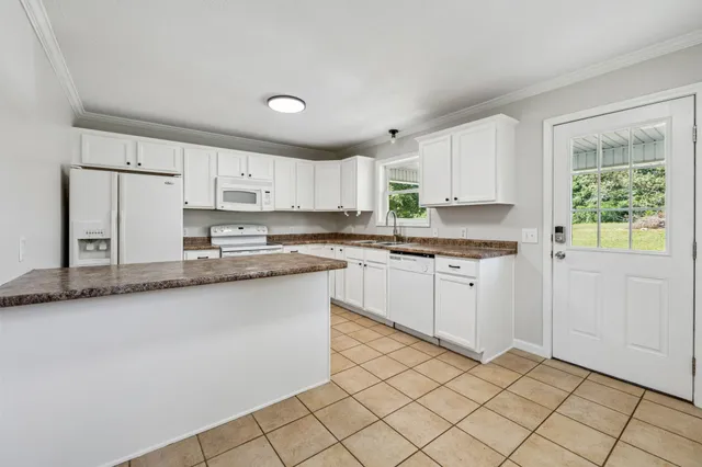 a bathroom with a granite countertop sink a mirror and a bathtub
