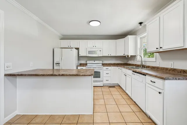 a bathroom with a granite countertop bathtub shower sink and vanity
