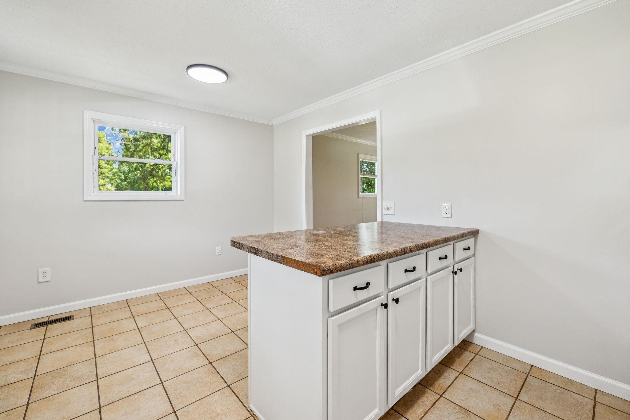 2585 Pow Road Baxter, TN 38544 - Photo 24 of 83 a kitchen with granite countertop a stove a sink and a window
