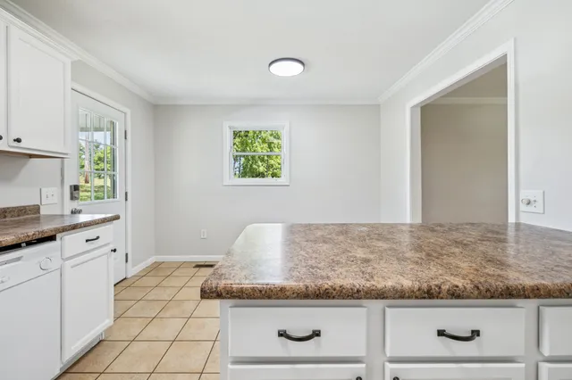 an empty room with wooden floor and ceiling fan
