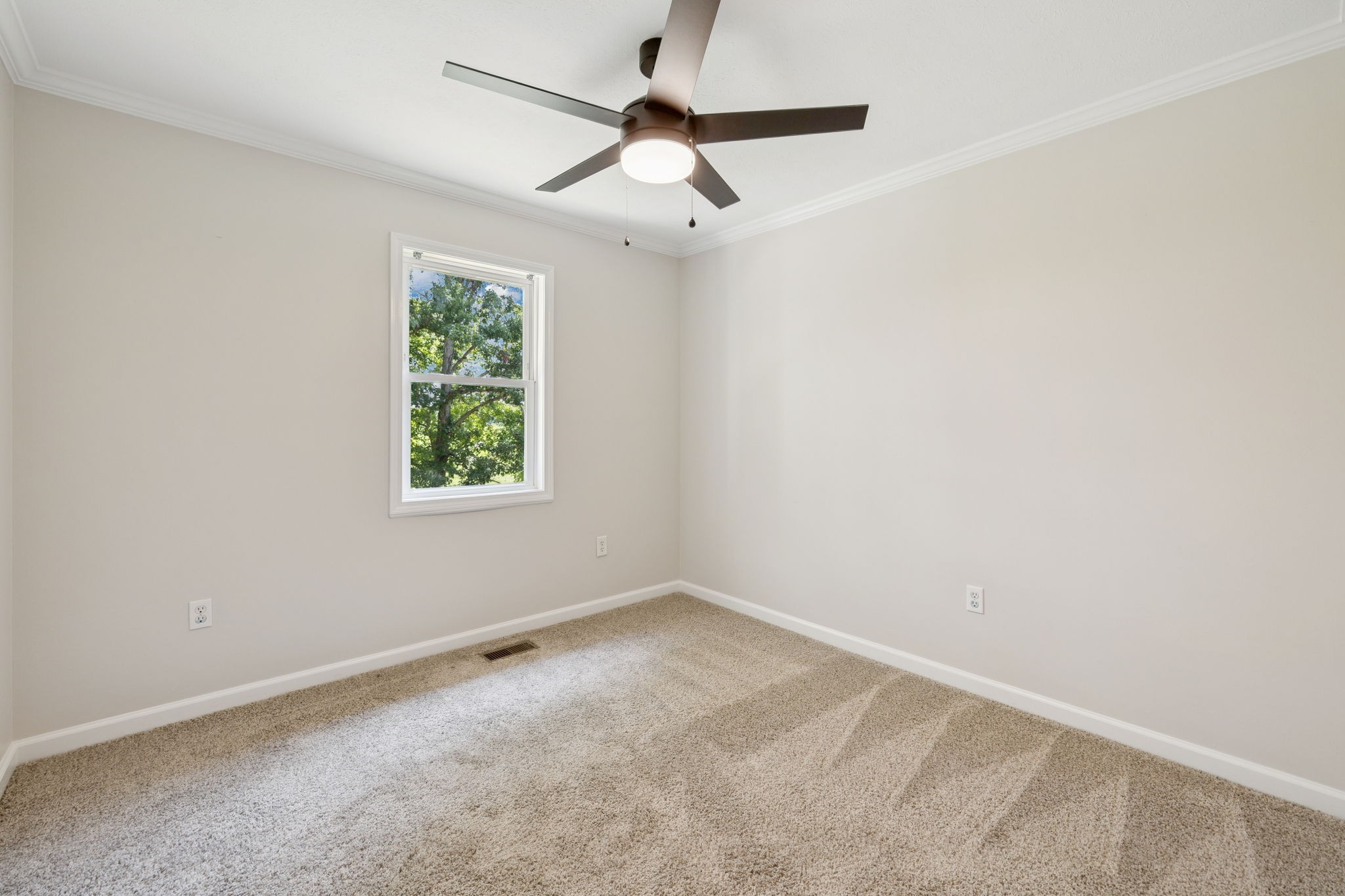 2585 Pow Road Baxter, TN 38544 - Photo 26 of 83 an empty room with a window and a fan