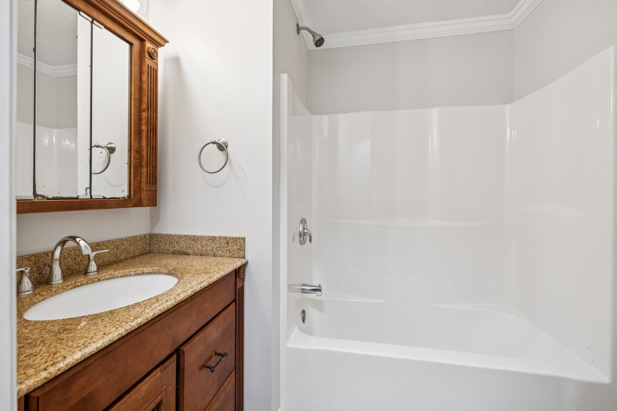 2585 Pow Road Baxter, TN 38544 - Photo 31 of 83 a bathroom with a granite countertop sink a mirror and a bathtub