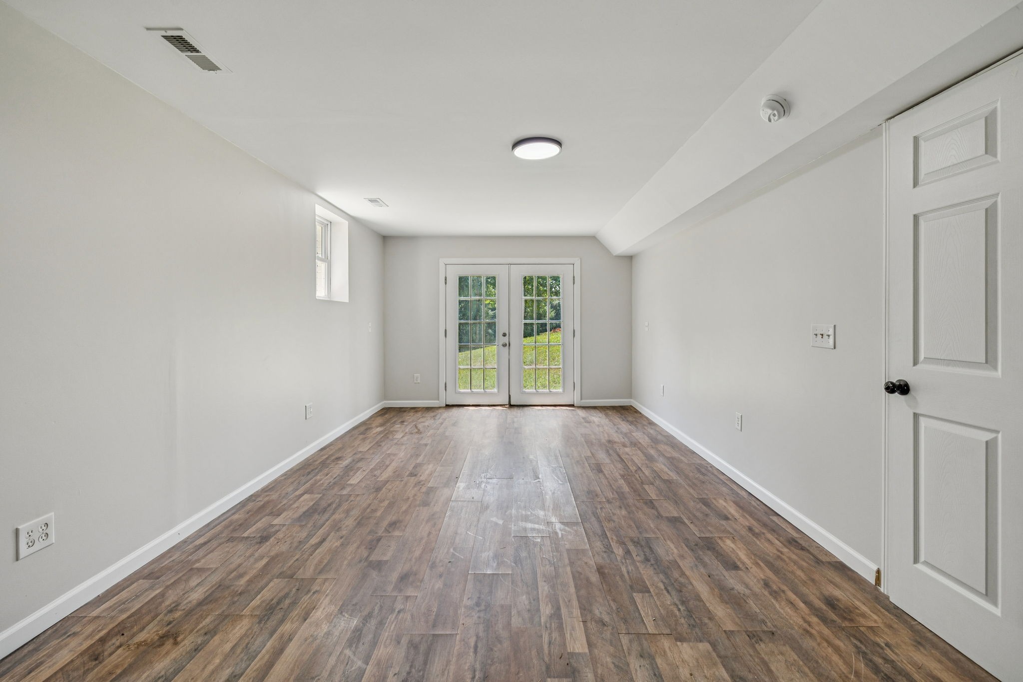 2585 Pow Road Baxter, TN 38544 - Photo 52 of 83 a view of an empty room with wooden floor and a window