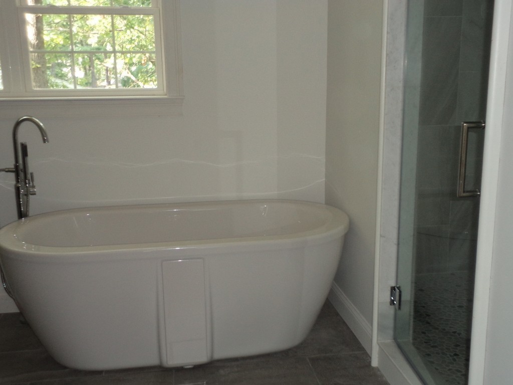 7 Abbott Road Natick, MA 01760 - Photo 27 of 30 a white bath tub sitting next to a window