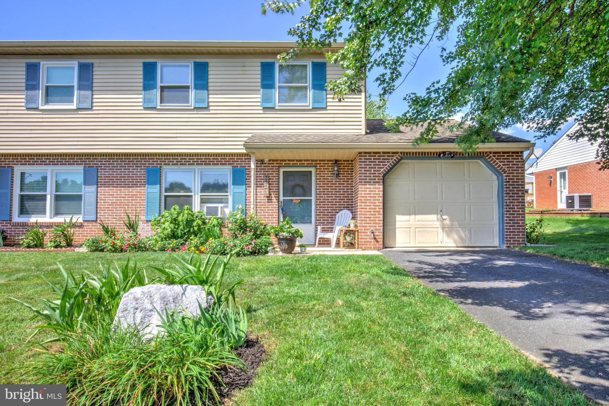 222 Miller Road Akron, PA 17501 - Photo 1 of 31 a front view of a house with a yard and shrubs