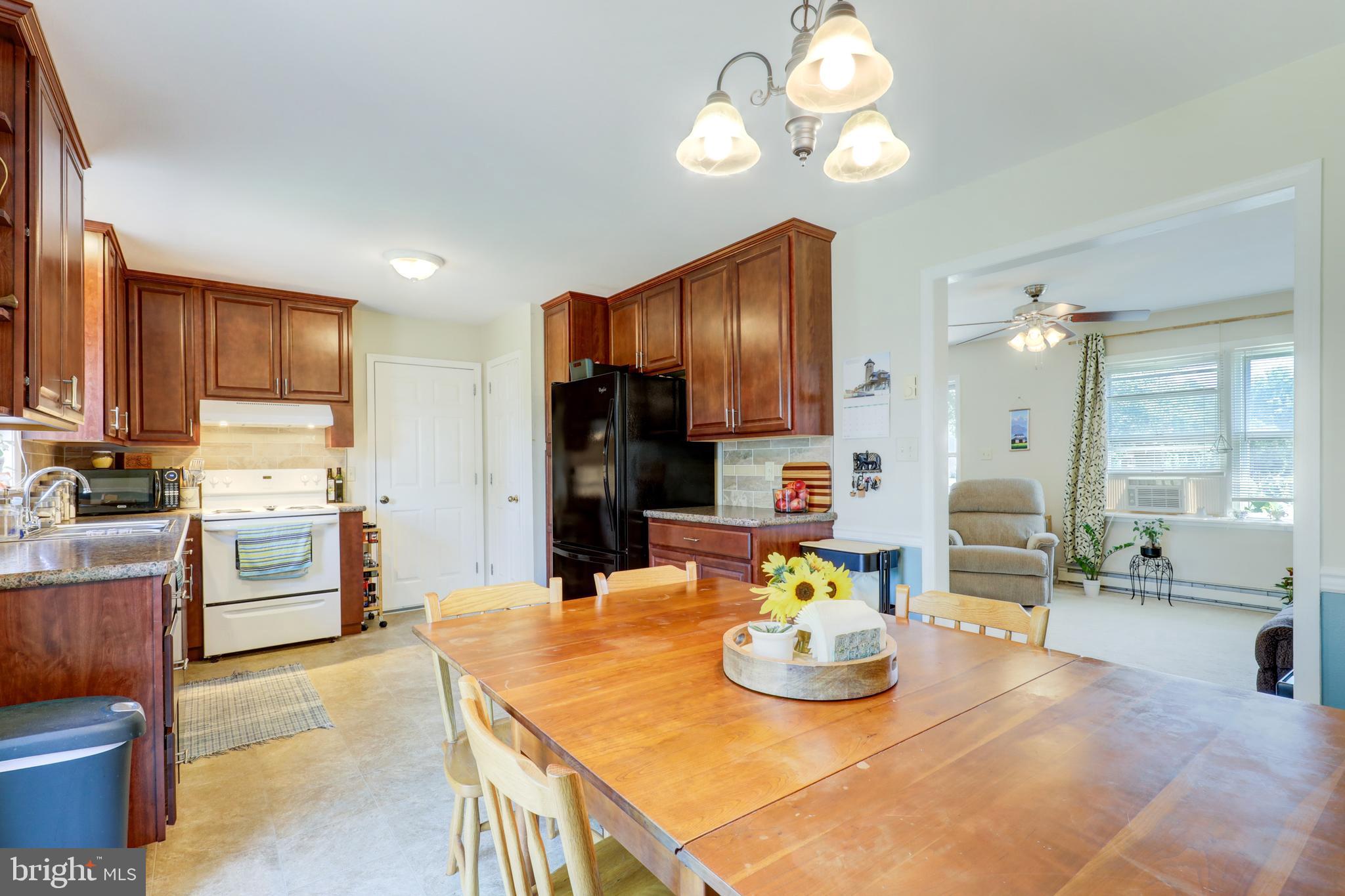 222 Miller Road Akron, PA 17501 - Photo 14 of 31 a kitchen with kitchen island stainless steel appliances a table and chairs
