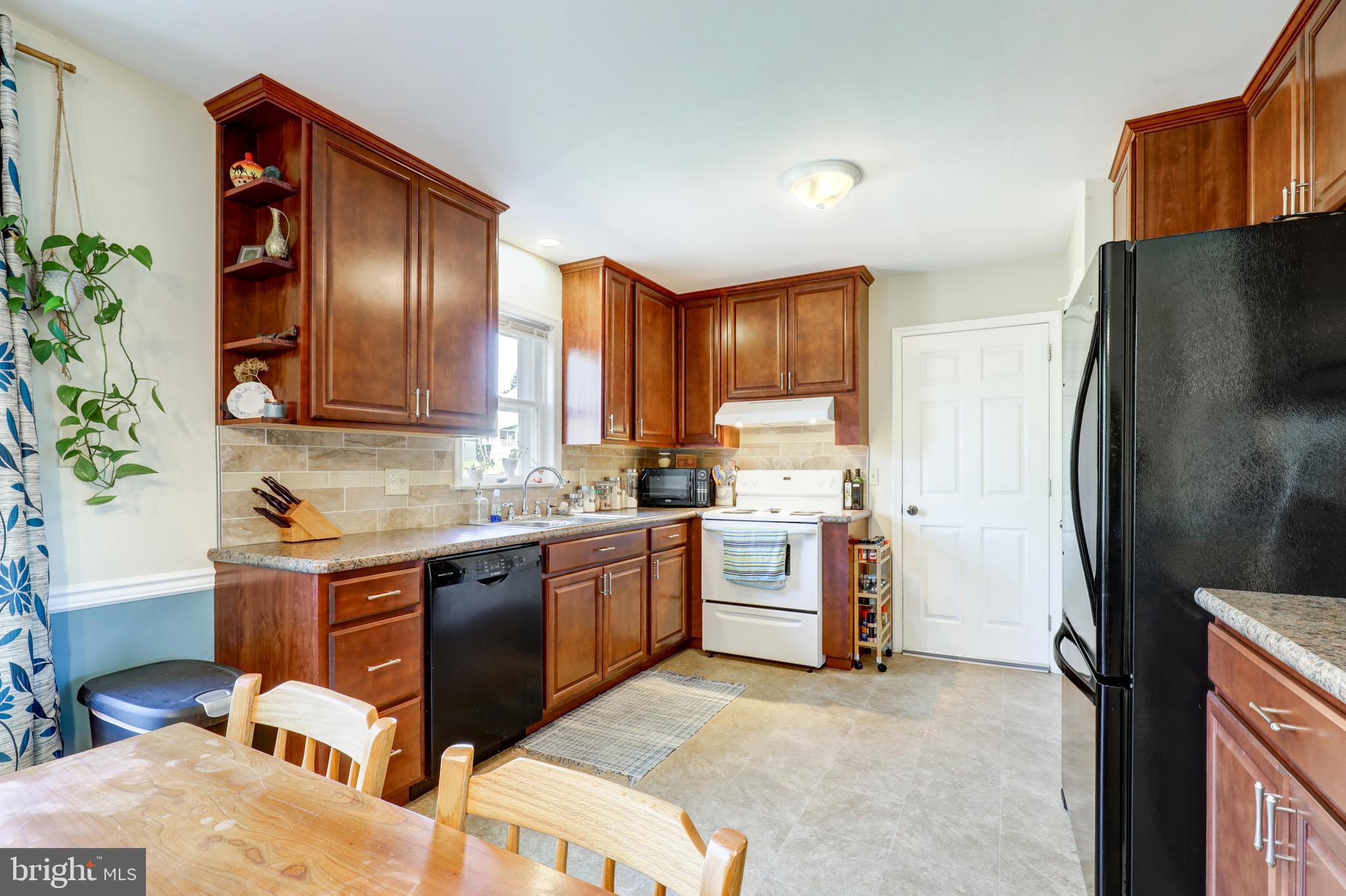 222 Miller Road Akron, PA 17501 - Photo 16 of 31 a kitchen with stainless steel appliances granite countertop a refrigerator a stove a sink and a microwave