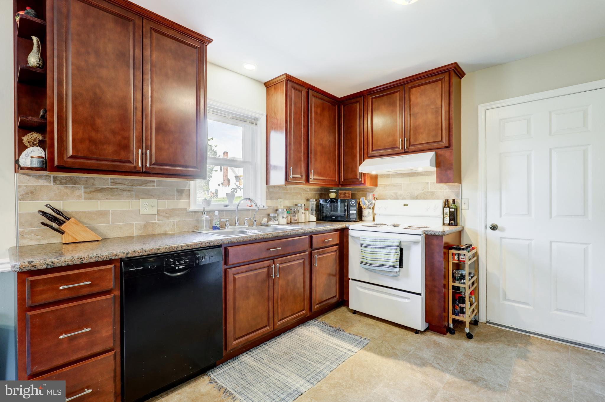 222 Miller Road Akron, PA 17501 - Photo 17 of 31 a kitchen with stainless steel appliances granite countertop a stove a sink and a refrigerator