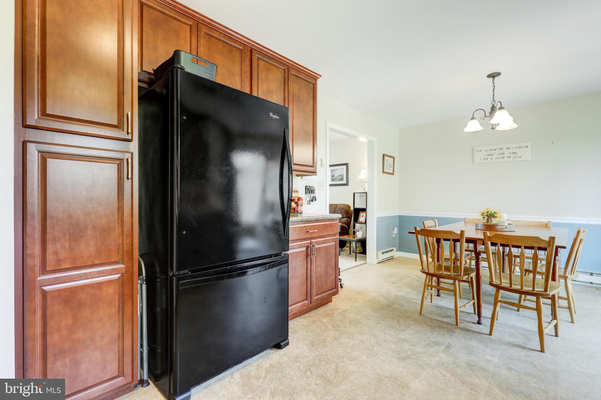 222 Miller Road Akron, PA 17501 - Photo 20 of 31 a kitchen with a refrigerator a table and chairs