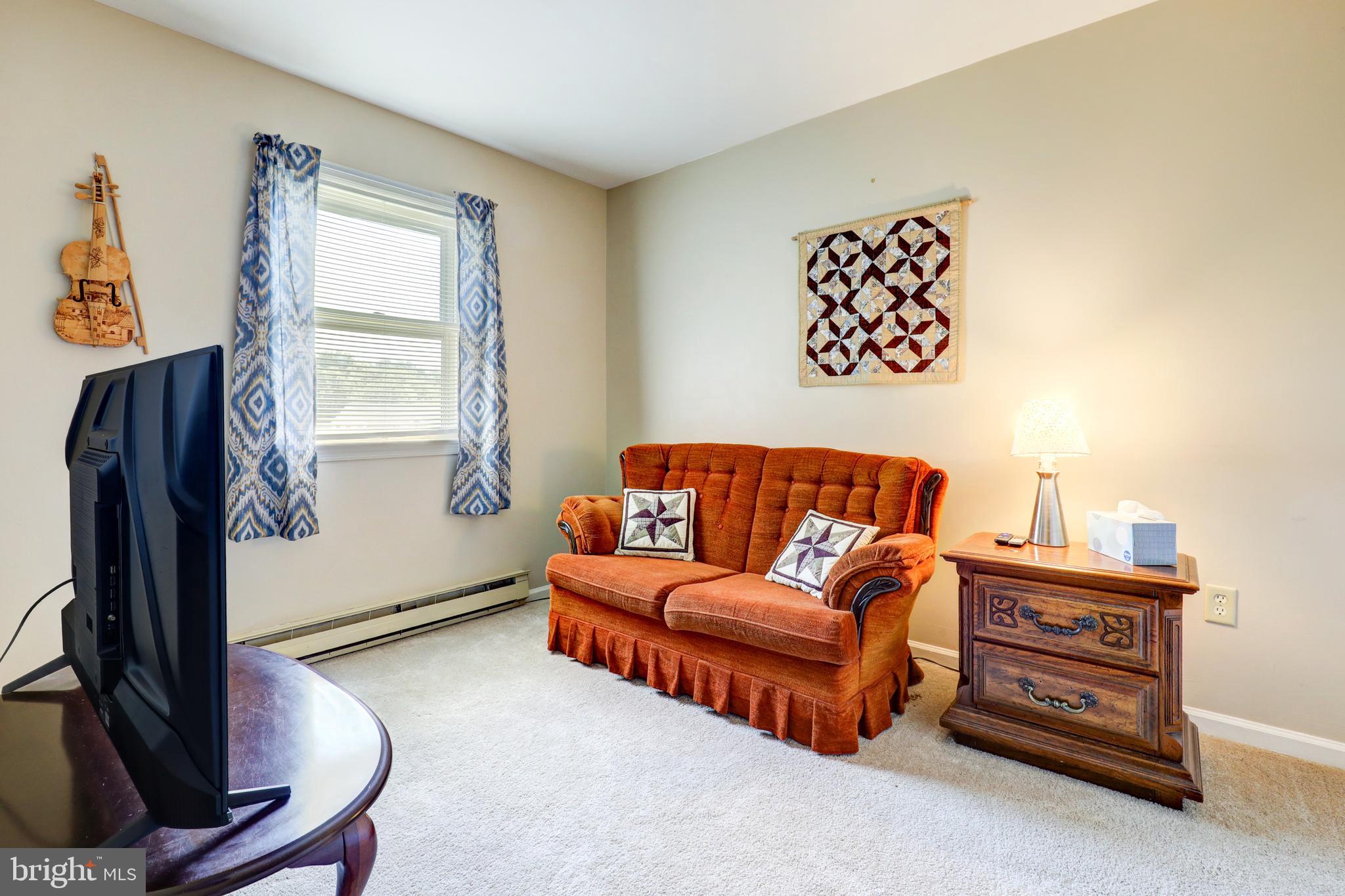 222 Miller Road Akron, PA 17501 - Photo 26 of 31 a living room with furniture a flat screen tv and a window