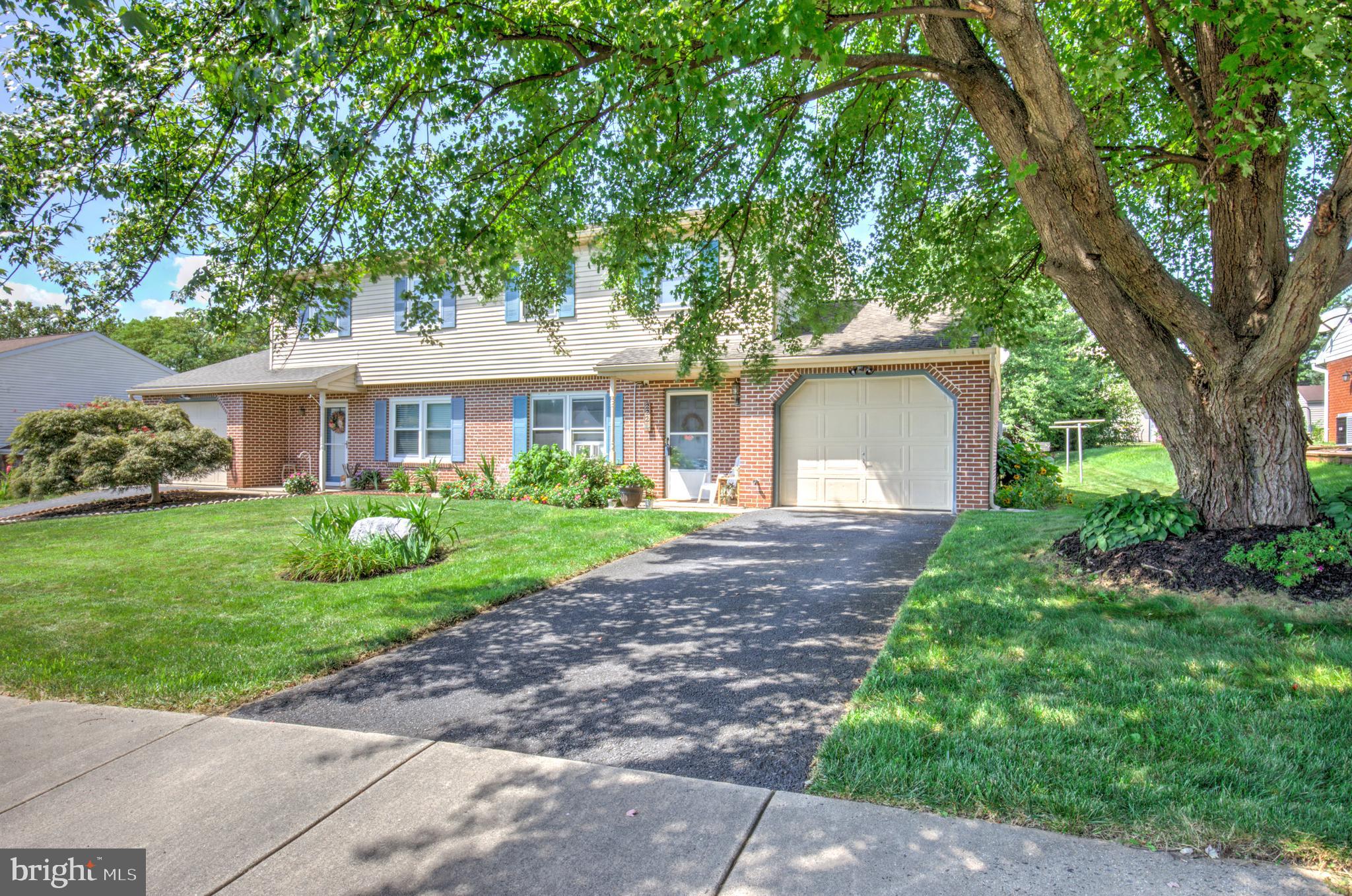 222 Miller Road Akron, PA 17501 - Photo 5 of 31 a front view of a house with a garden