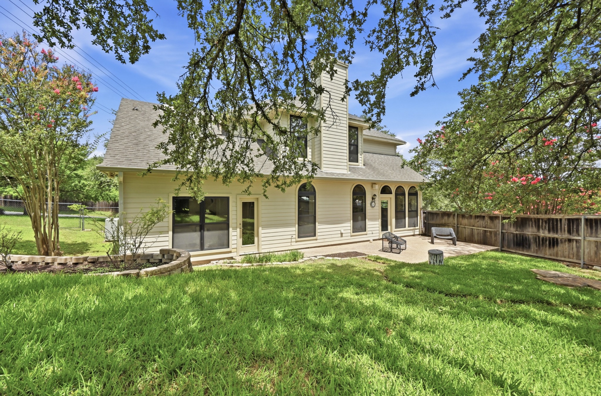1107 Bowie Road Austin, TX 78733 - Photo 35 of 40 A well-maintained lawn and patio space create a delightful outdoor haven.