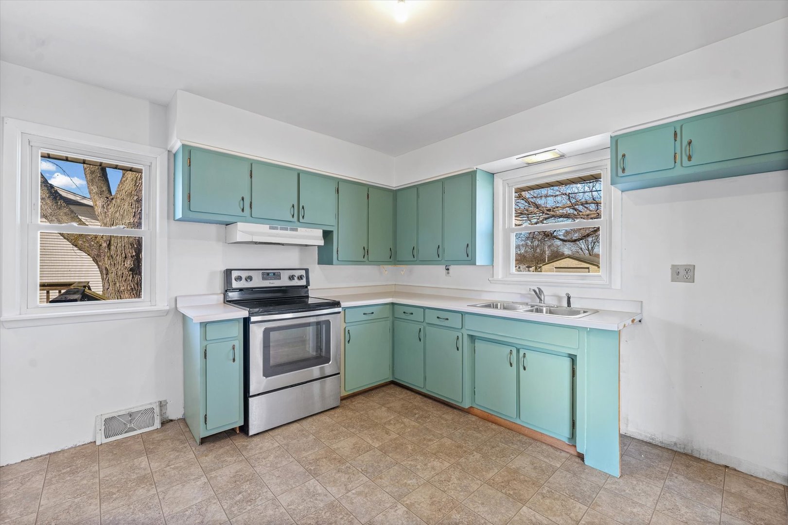 404 South Maple Street Gilman, IL 60938 - Photo 11 of 28 a kitchen with a sink stove and microwave