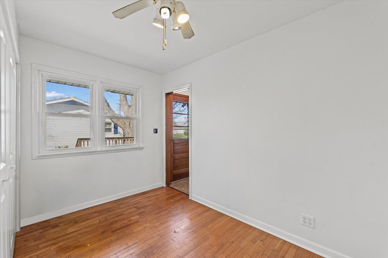 404 South Maple Street Gilman, IL 60938 - Photo 15 of 28 wooden floor in an empty room with a window